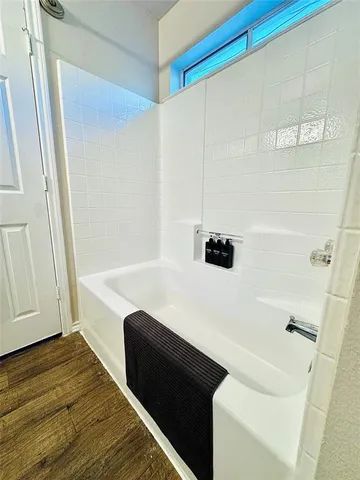 a bedroom with a bed and painting on the wall