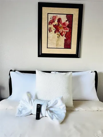 a bedroom with a large bed and a flat screen tv