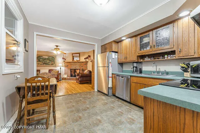 a kitchen with stainless steel appliances granite countertop sink stove and refrigerator