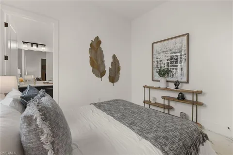 a bedroom with a bed and a mirror