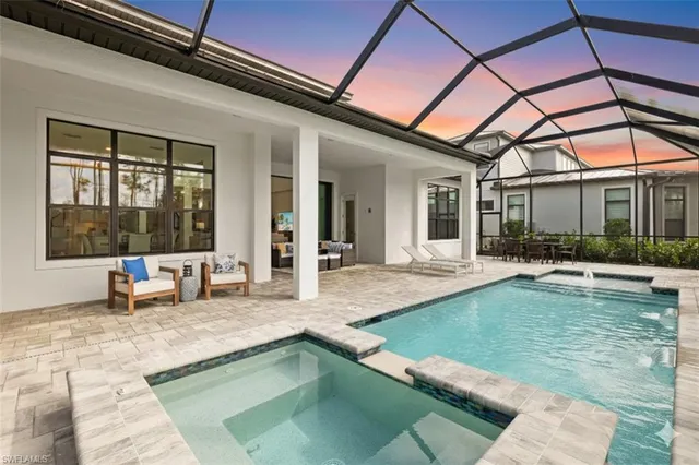a view of a house with swimming pool and sitting area