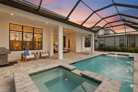 a swimming pool with outdoor seating and a couch