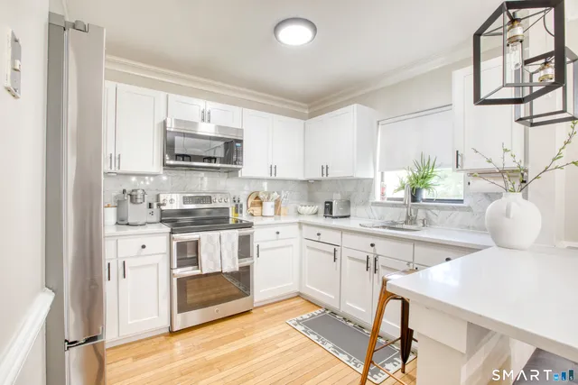 a kitchen with a sink cabinets and window