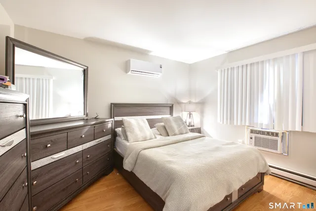 a bedroom with a bed and a large window