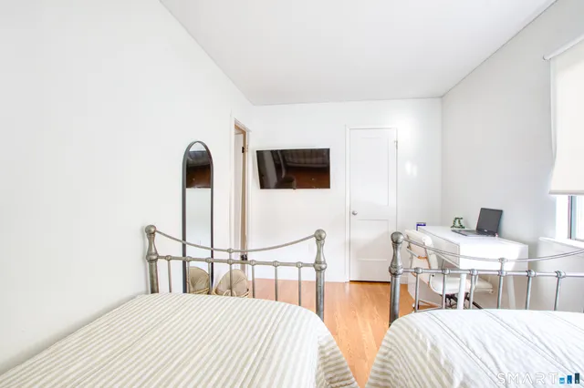 a bedroom with double bed and a window