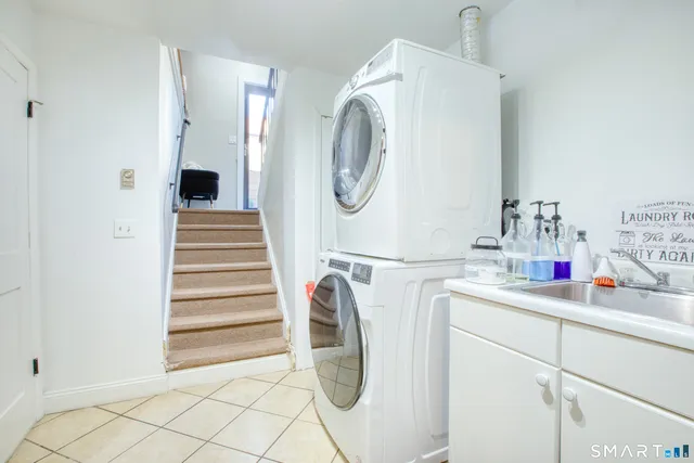 a utility room with sink dryer and washer