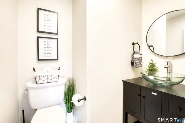 a bathroom with a toilet sink and mirror