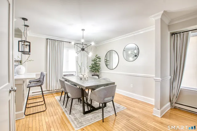 a view of a dining room with furniture and wooden floor