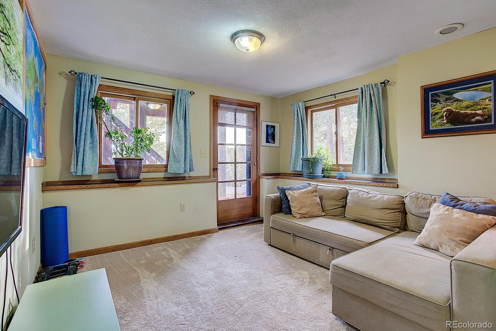 1983 Ridge Road Nederland, CO 80466 - Photo 23 of 30 a living room with furniture and a large window