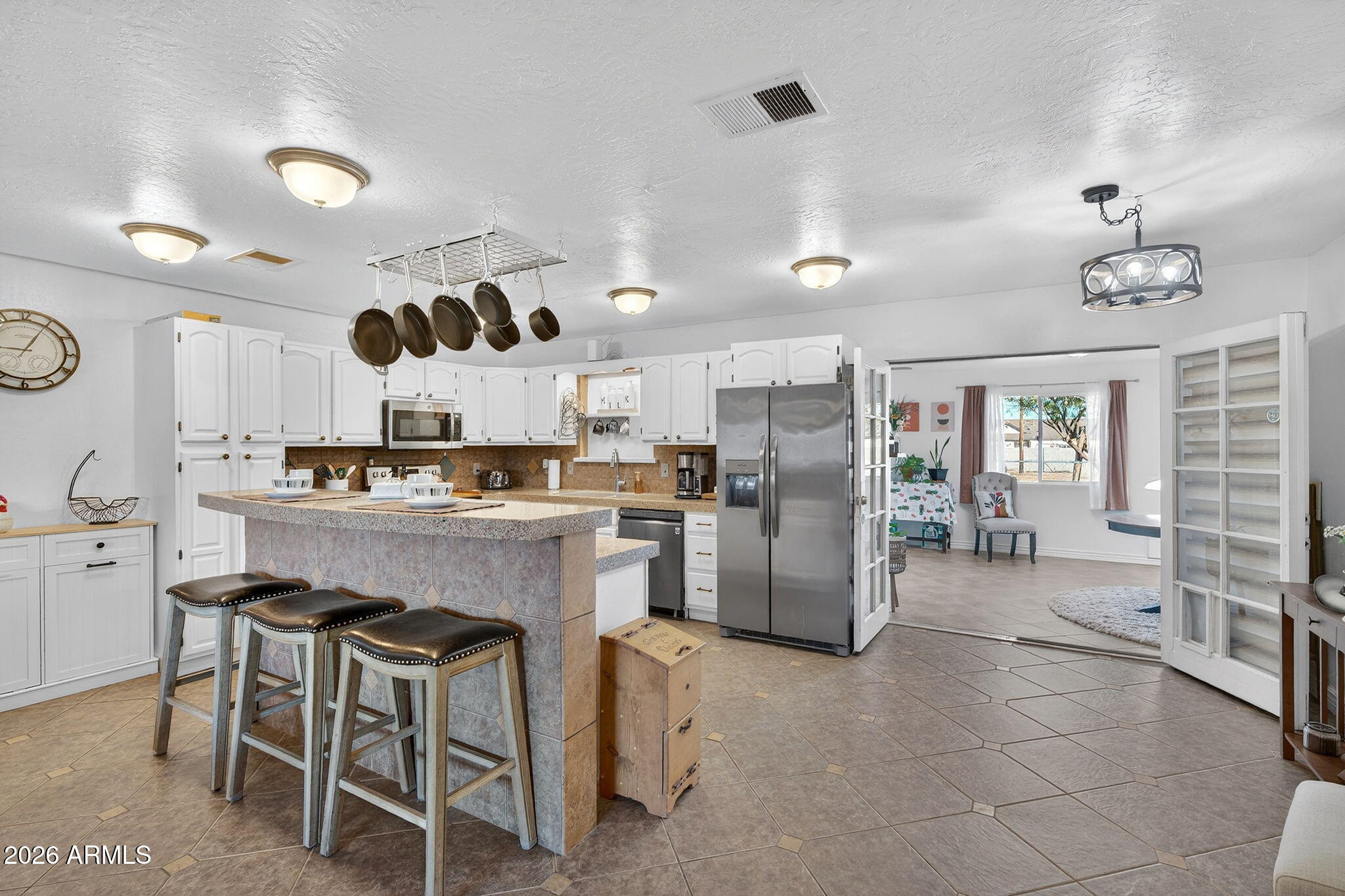 13202 West Ocotillo Road Glendale, AZ 85307 - Photo 15 of 58 a kitchen with refrigerator and cabinets