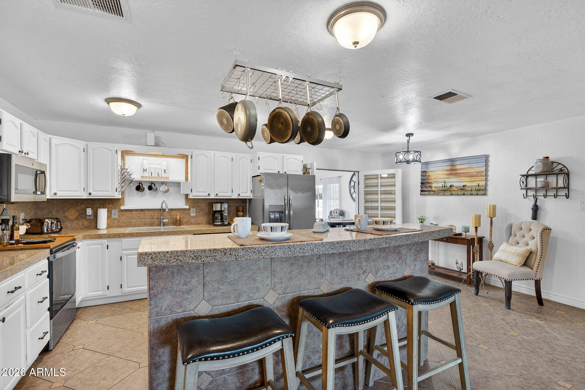 13202 West Ocotillo Road Glendale, AZ 85307 - Photo 16 of 58 a kitchen with stainless steel appliances granite countertop a sink and a refrigerator