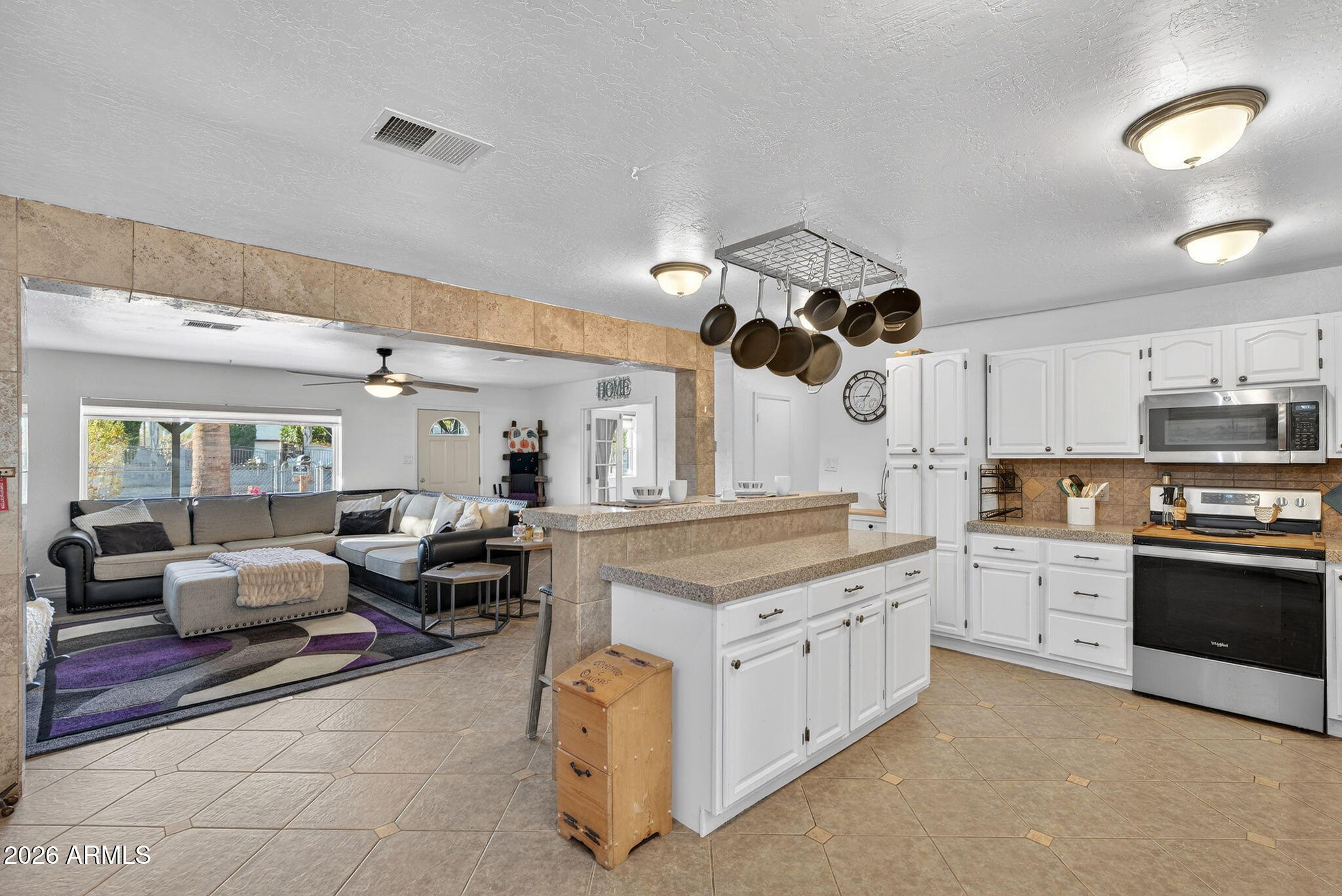 13202 West Ocotillo Road Glendale, AZ 85307 - Photo 17 of 58 a kitchen with a stove oven and a view of living room