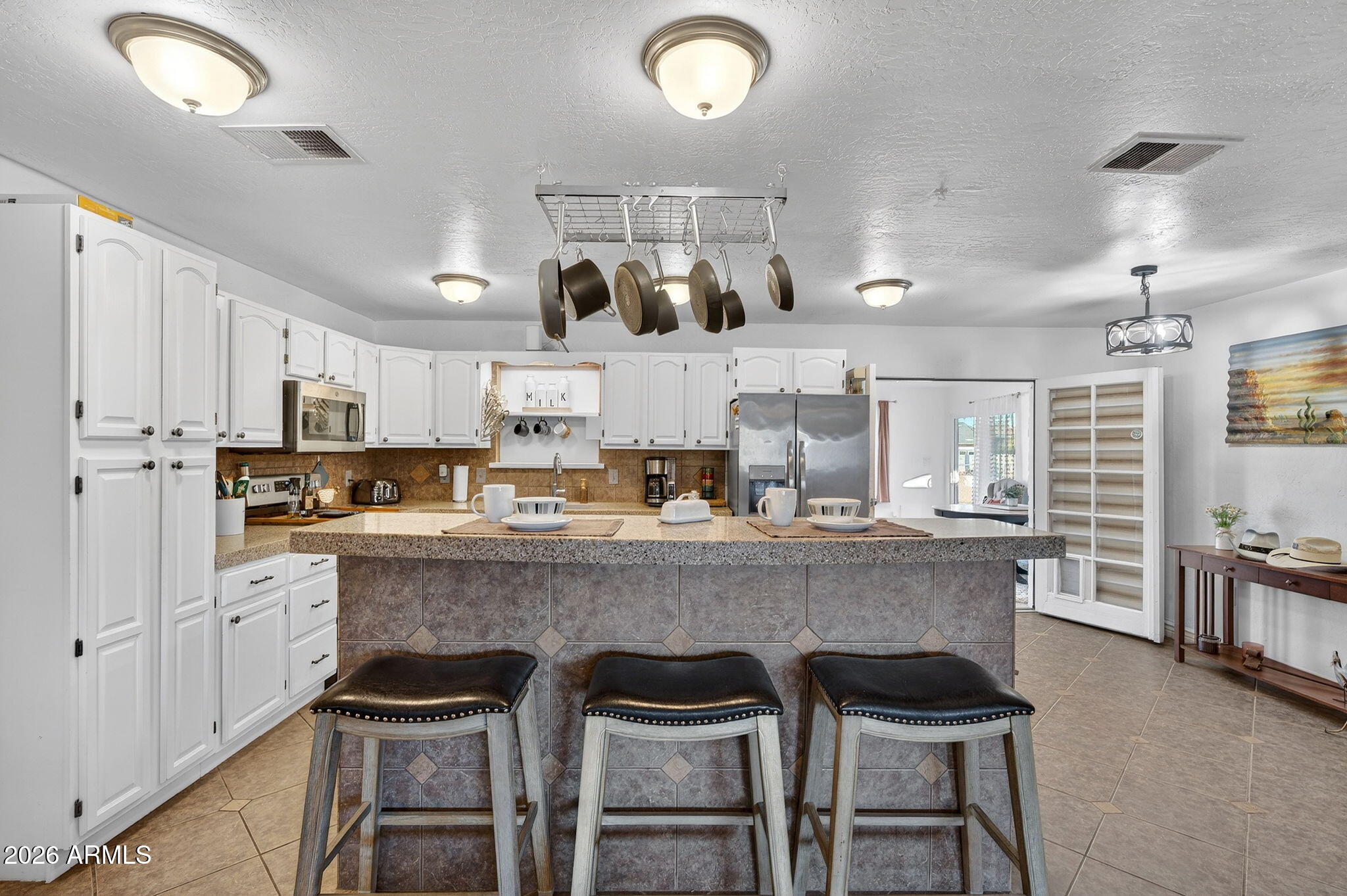 13202 West Ocotillo Road Glendale, AZ 85307 - Photo 18 of 58 a large kitchen with a table and chairs in it