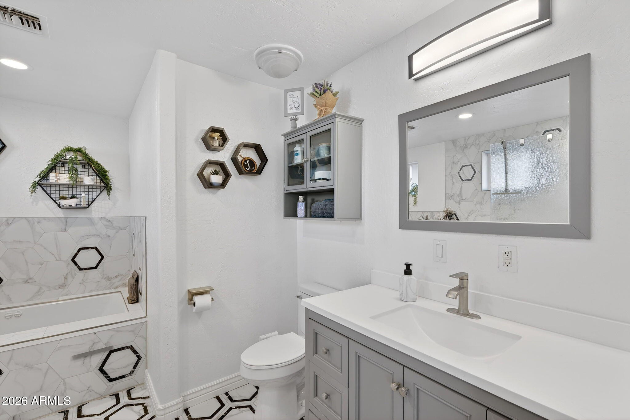 13202 West Ocotillo Road Glendale, AZ 85307 - Photo 28 of 58 a bathroom with a toilet a sink and mirror