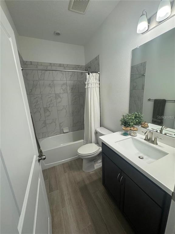 4356 Reisswood Loop Palmetto, FL 34221 - Photo 14 of 17 a bathroom with a sink a toilet a mirror and shower