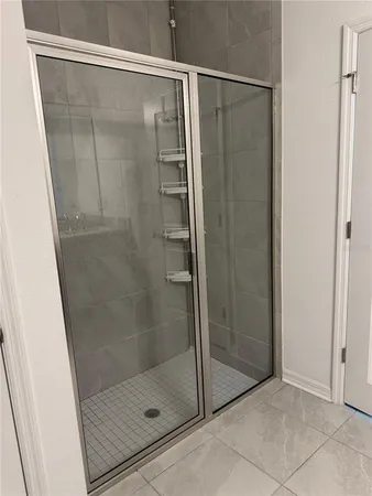 a bathroom with a glass shower door
