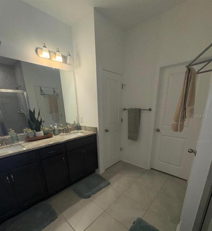 4356 Reisswood Loop Palmetto, FL 34221 - Photo 10 of 17 a bathroom with a double vanity sink and mirror