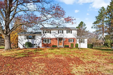 a view of a house with a large tree in front of a house