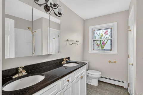 a bathroom with a painting on the wall and shower