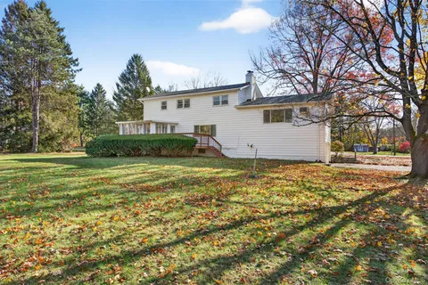 a view of a house with a yard covered in snow