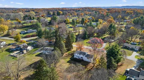 a view of yard with tree in front of it