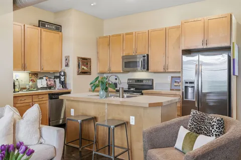 a kitchen with stainless steel appliances a sink stove and refrigerator