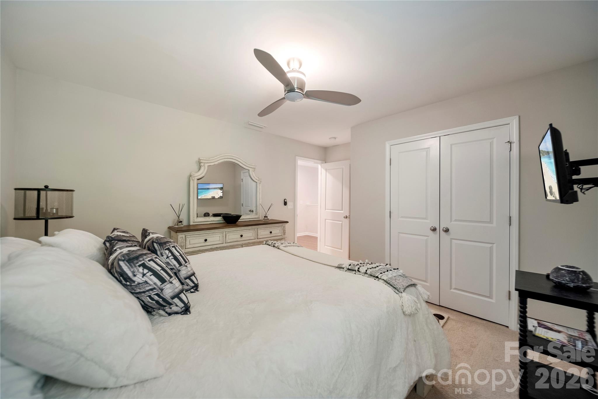 8122 Mossy Rock Road Waxhaw, NC 28173 - Photo 18 of 28 a bedroom with a bed and a chandelier