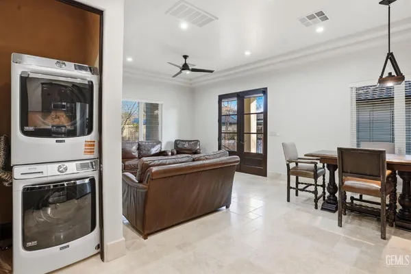 a living room with furniture a flat screen tv and a window