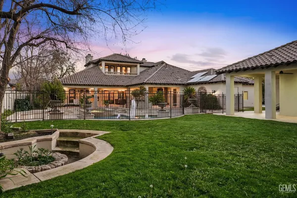 a bathroom with double vanity and two mirrors