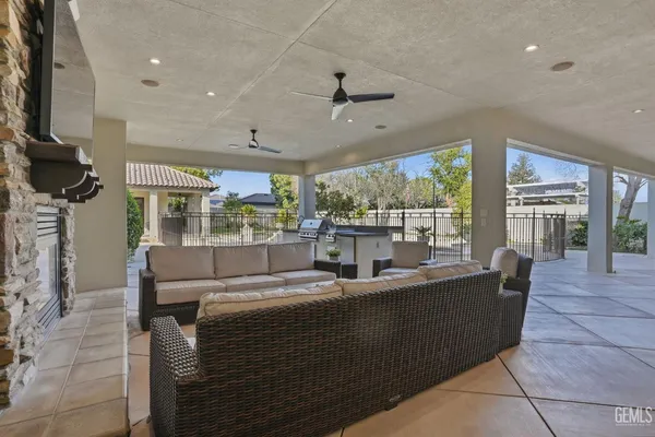 a view of a house with a yard potted plants and large tree