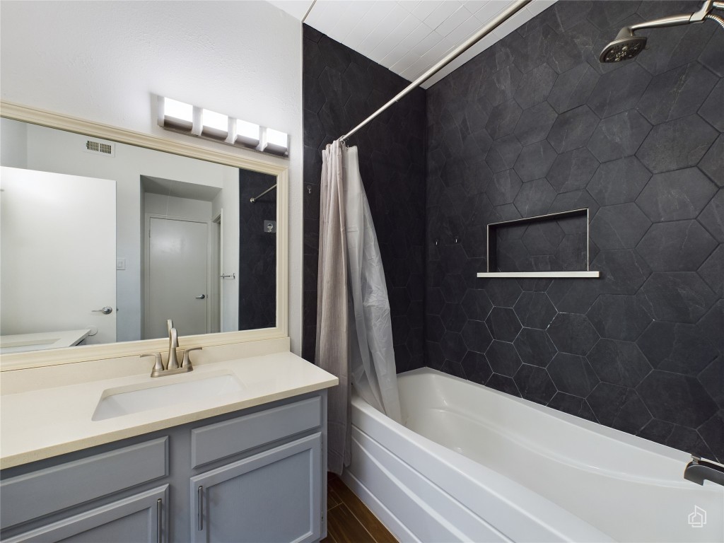 2450 Wickersham Lane, Unit 501 Austin, TX 78741 - Photo 12 of 21 a bathroom with a tub a sink and mirrors