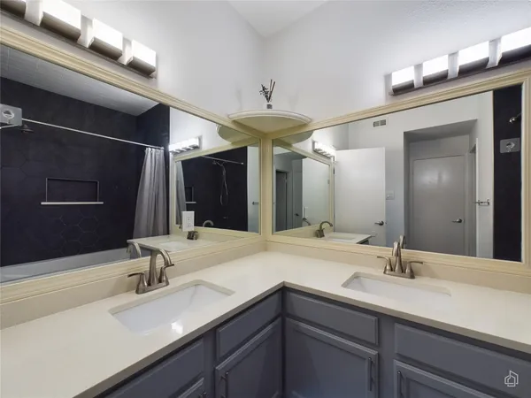 an empty room with windows and ceiling fan