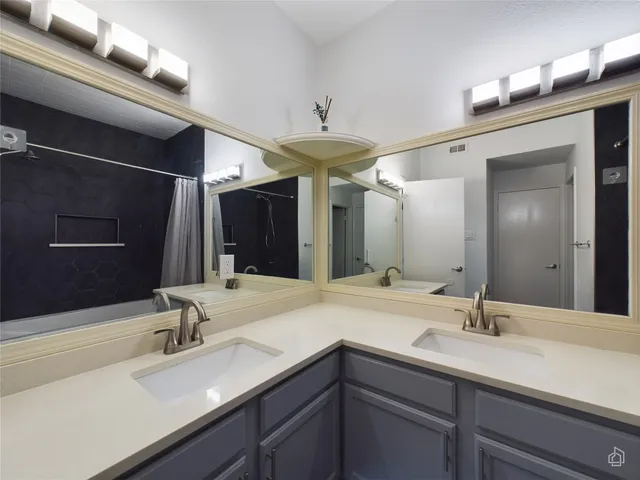 an empty room with windows and ceiling fan