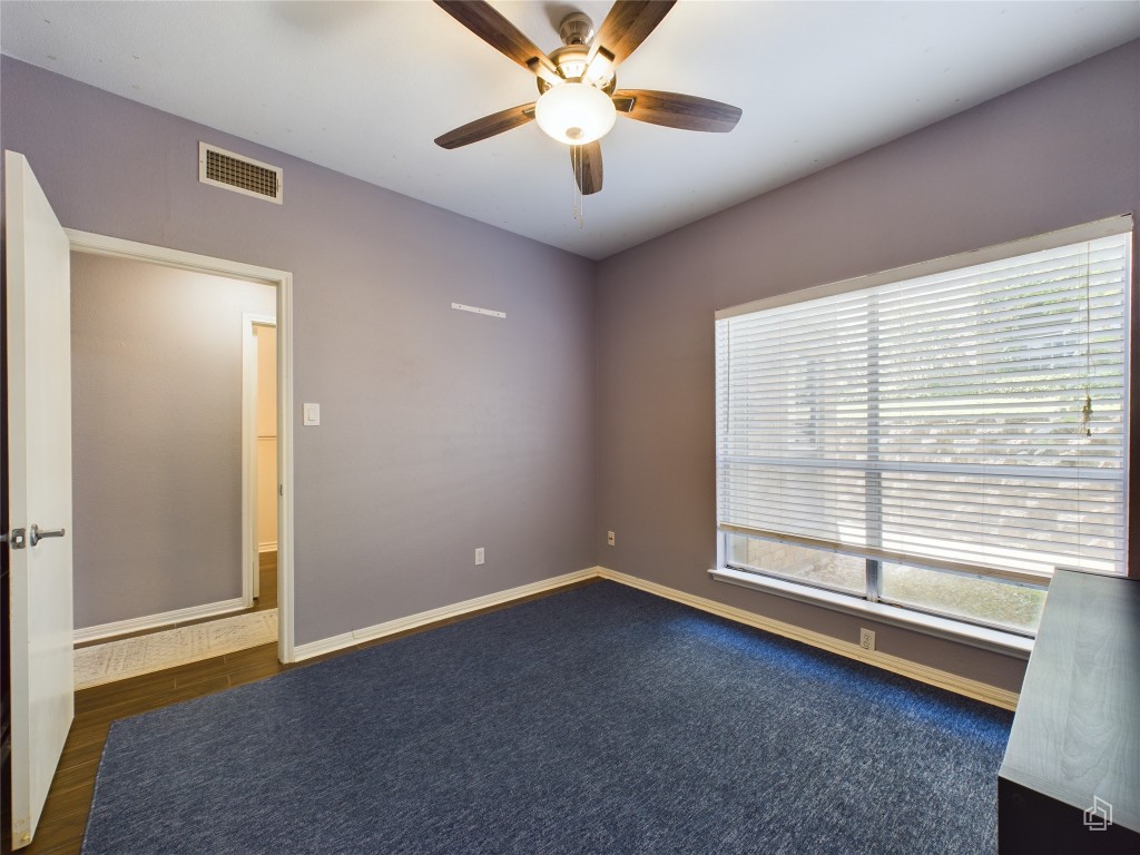 2450 Wickersham Lane, Unit 501 Austin, TX 78741 - Photo 14 of 21 an empty room with windows and ceiling fan