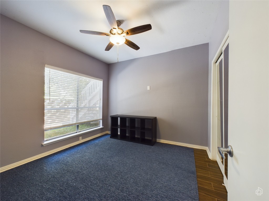 2450 Wickersham Lane, Unit 501 Austin, TX 78741 - Photo 15 of 21 an empty room with windows and fan