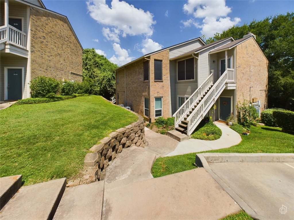 2450 Wickersham Lane, Unit 501 Austin, TX 78741 - Photo 20 of 21 a view of a house with a yard