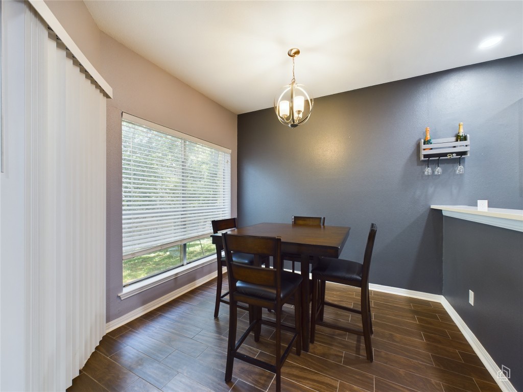 2450 Wickersham Lane, Unit 501 Austin, TX 78741 - Photo 5 of 21 a view of a dining room with furniture wooden floor and chandelier