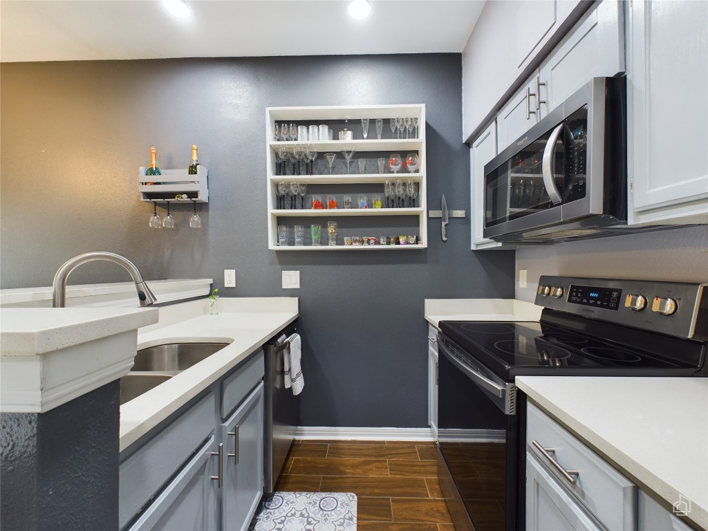 2450 Wickersham Lane, Unit 501 Austin, TX 78741 - Photo 7 of 21 a kitchen with stainless steel appliances a sink and a stove