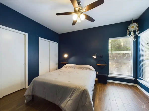 a bedroom with a bed and a ceiling fan