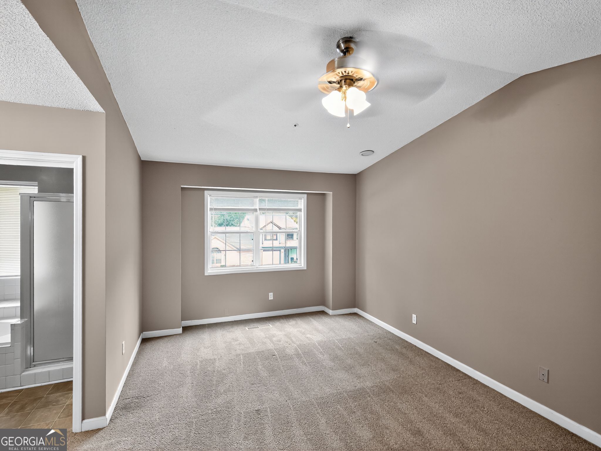 3604 Spring Trace Decatur, GA 30034 - Photo 17 of 32 an empty room with windows and chandelier fan