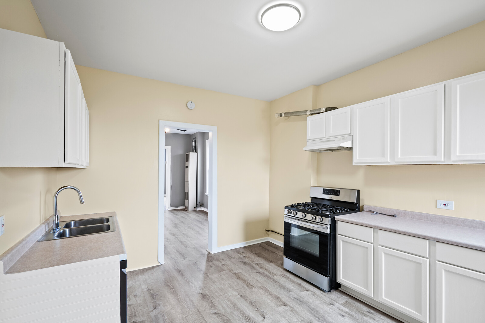1331 West Huron Street Chicago, IL 60642 - Photo 4 of 11 a kitchen with granite countertop a sink cabinets and stainless steel appliances