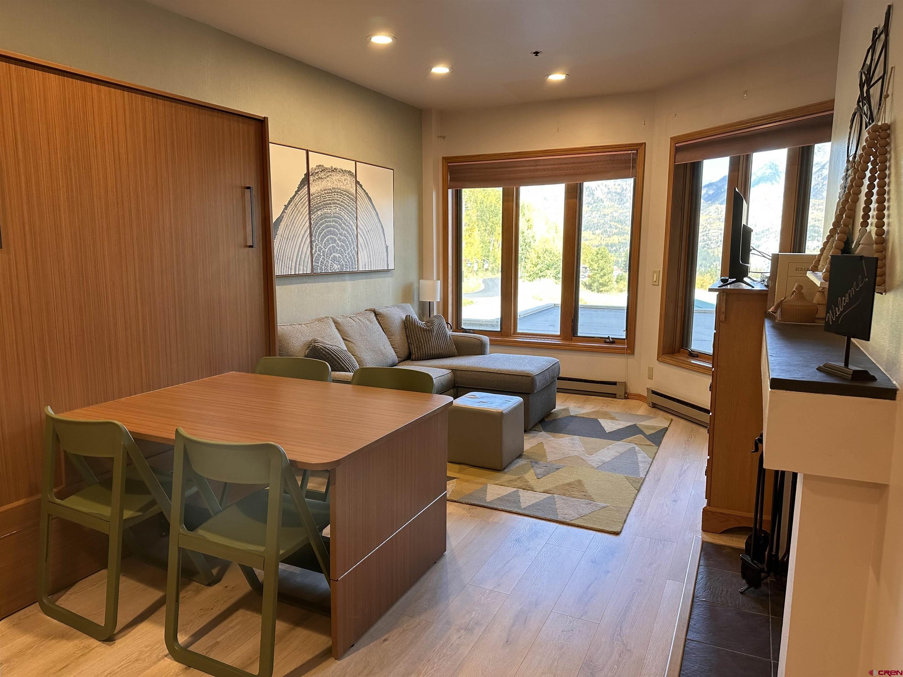 71 Needles Way, Unit 340 Durango, CO 81301 - Photo 6 of 40 a living room with furniture a flat screen tv and a large window
