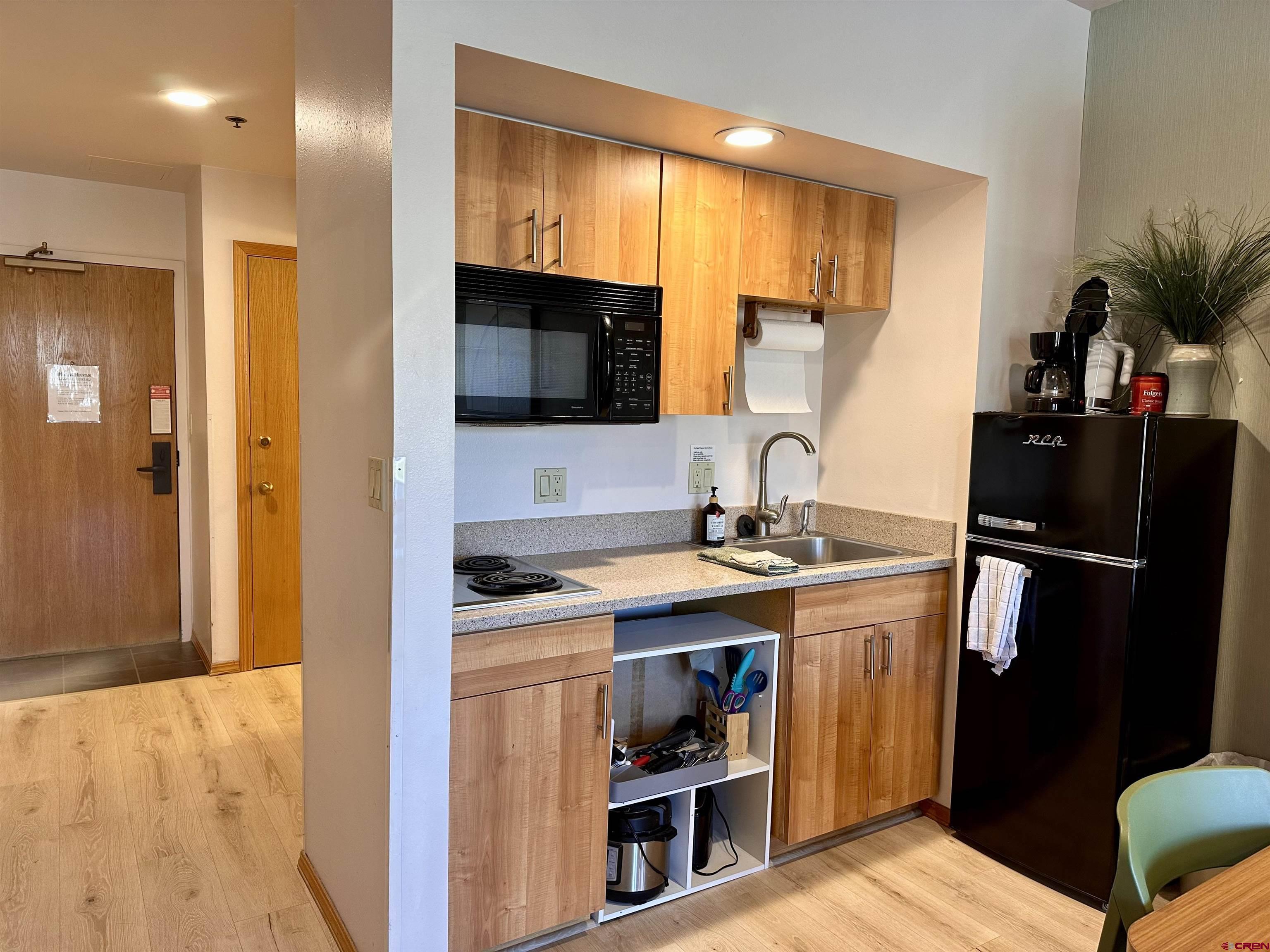 71 Needles Way, Unit 340 Durango, CO 81301 - Photo 8 of 40 a view of a kitchen with a sink and a refrigerator