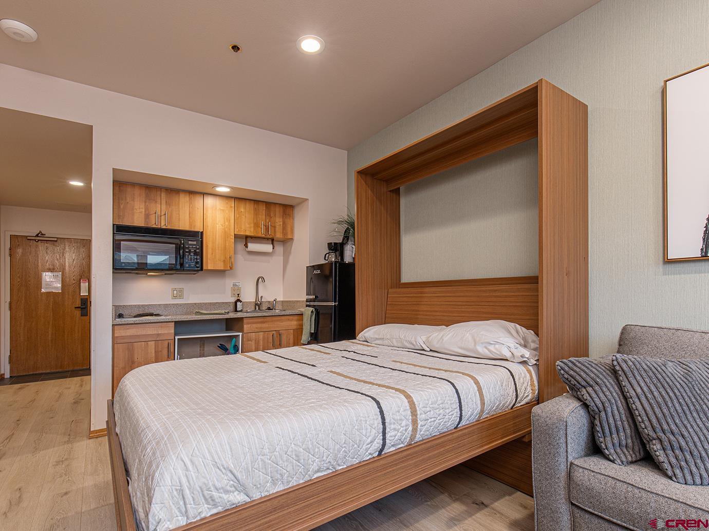 71 Needles Way, Unit 340 Durango, CO 81301 - Photo 9 of 40 a bedroom with a large bed and a flat tv screen
