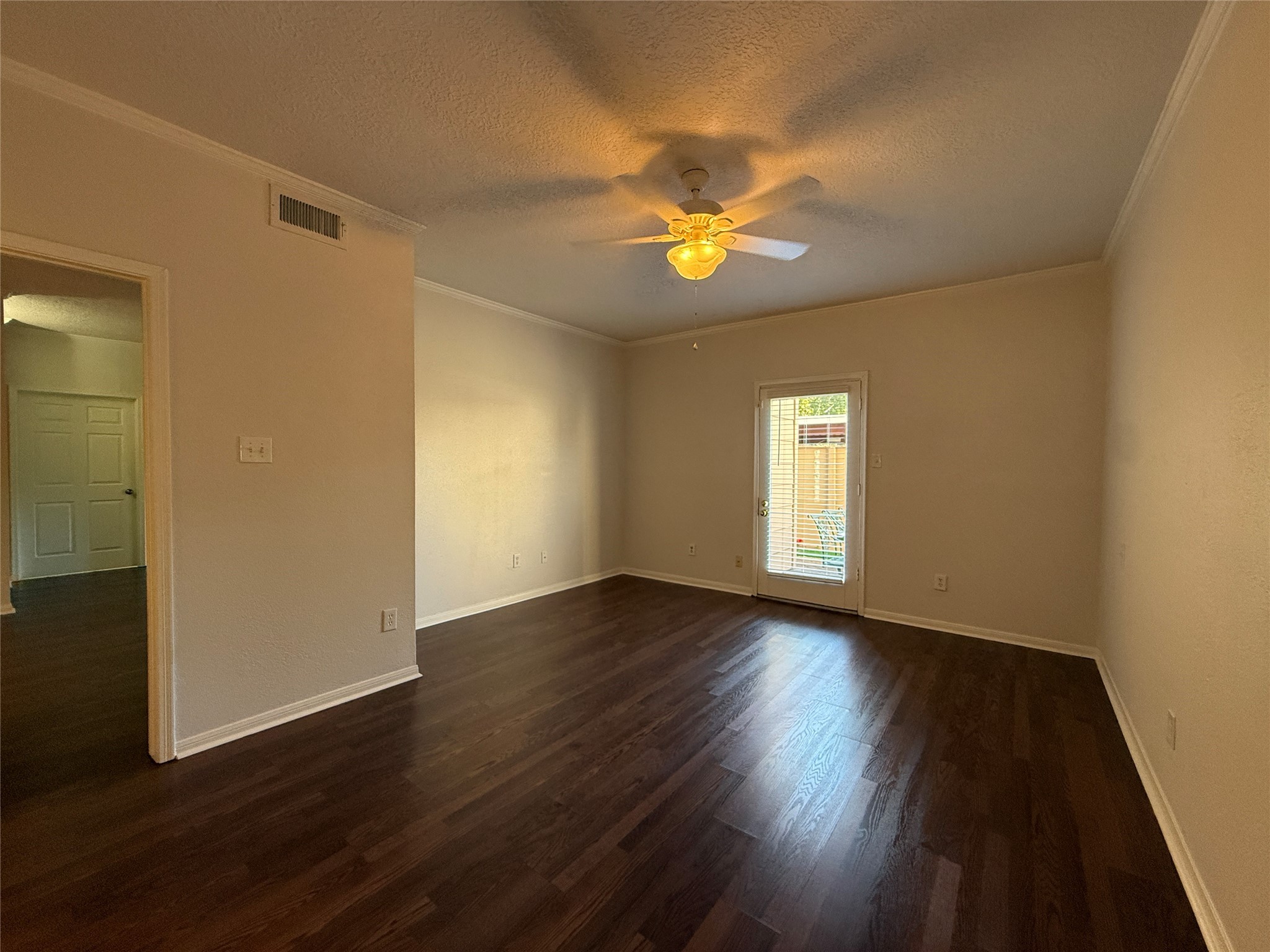 2125 Augusta Drive, Unit 83 Houston, TX 77057 - Photo 16 of 34 an empty room with wooden floor and windows
