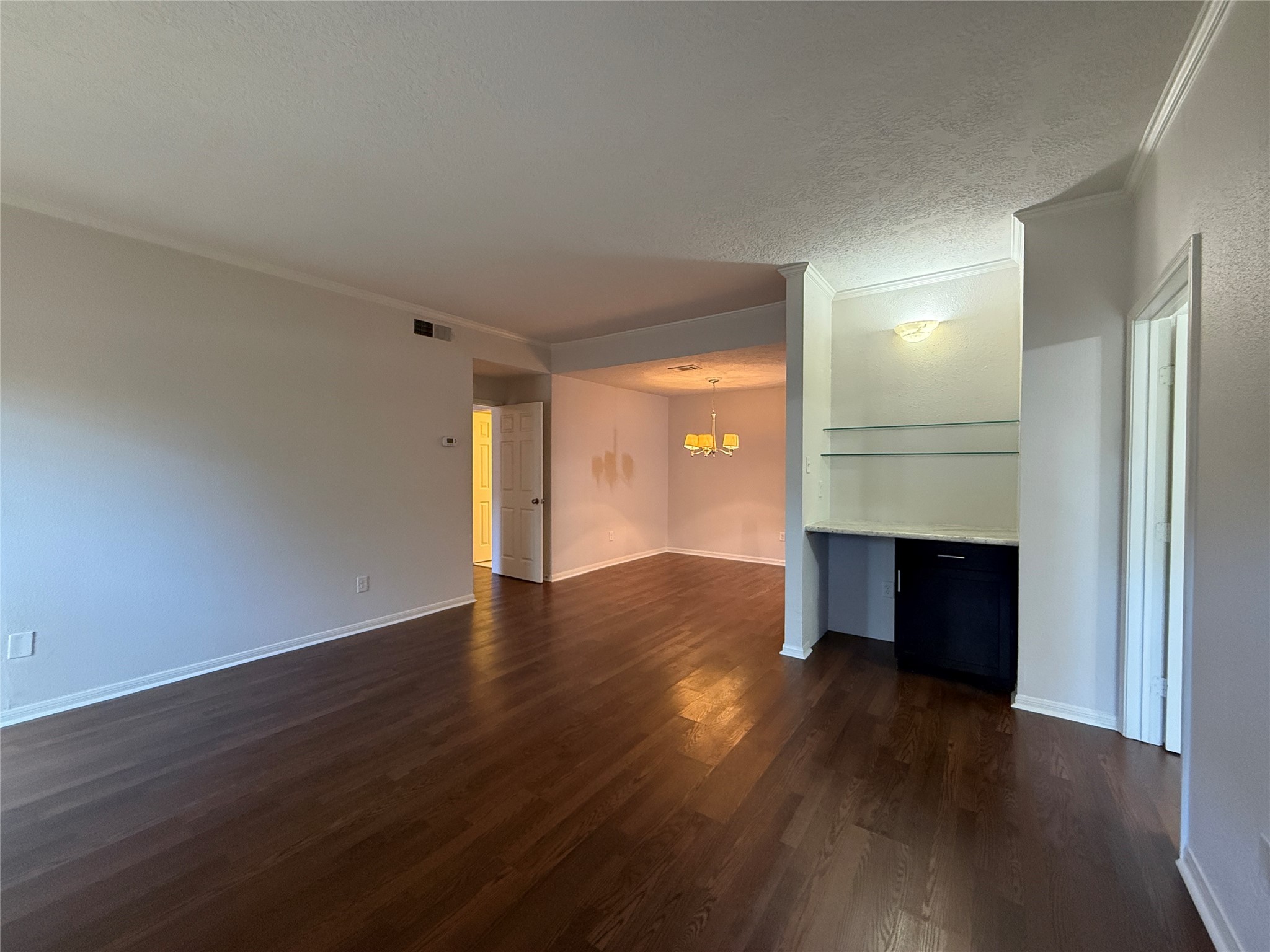 2125 Augusta Drive, Unit 83 Houston, TX 77057 - Photo 7 of 34 a view of an empty room with wooden floor and a window