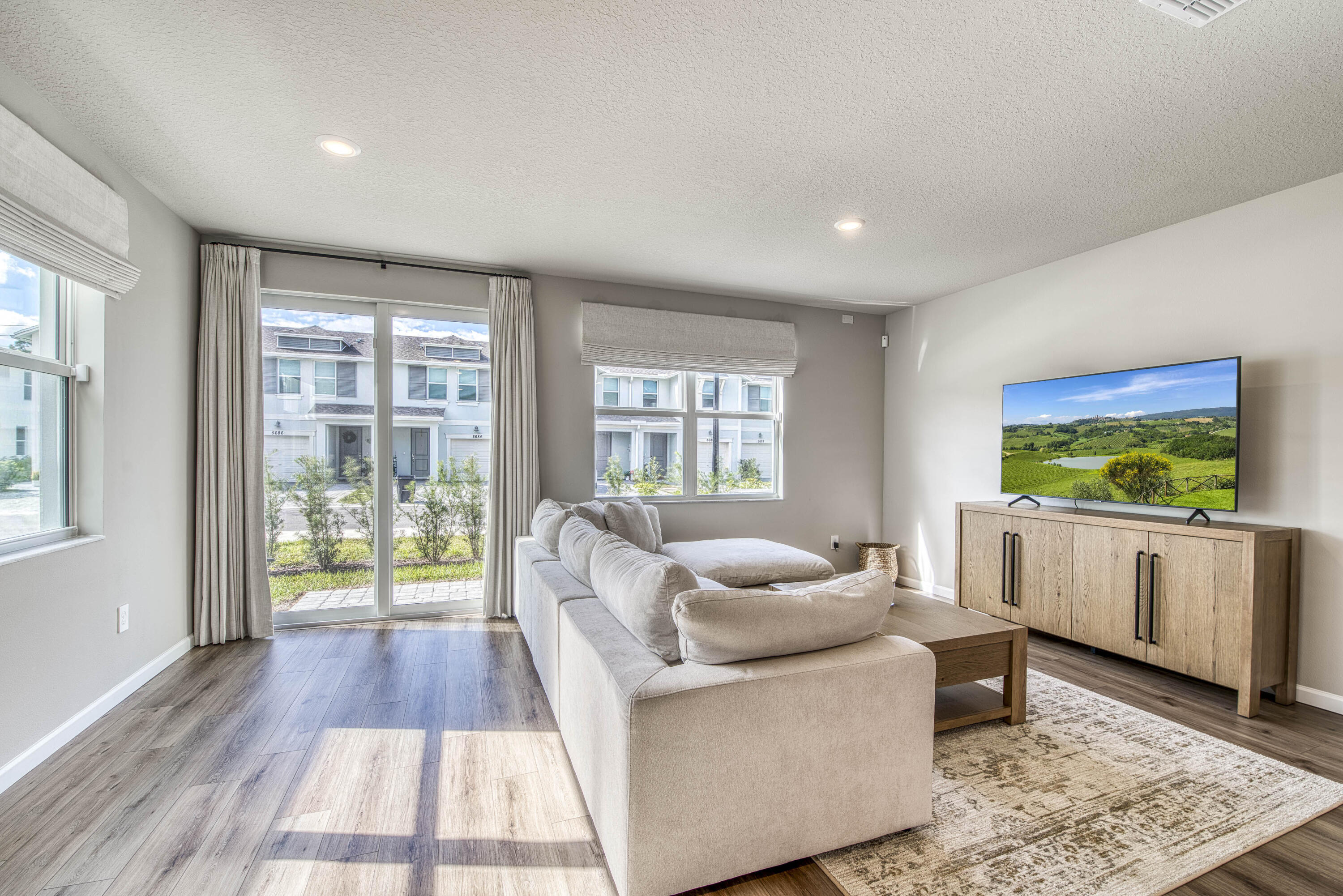 5735 Southeast Edgewater Circle Stuart, FL 34997 - Photo 11 of 39 a living room with furniture and a flat screen tv