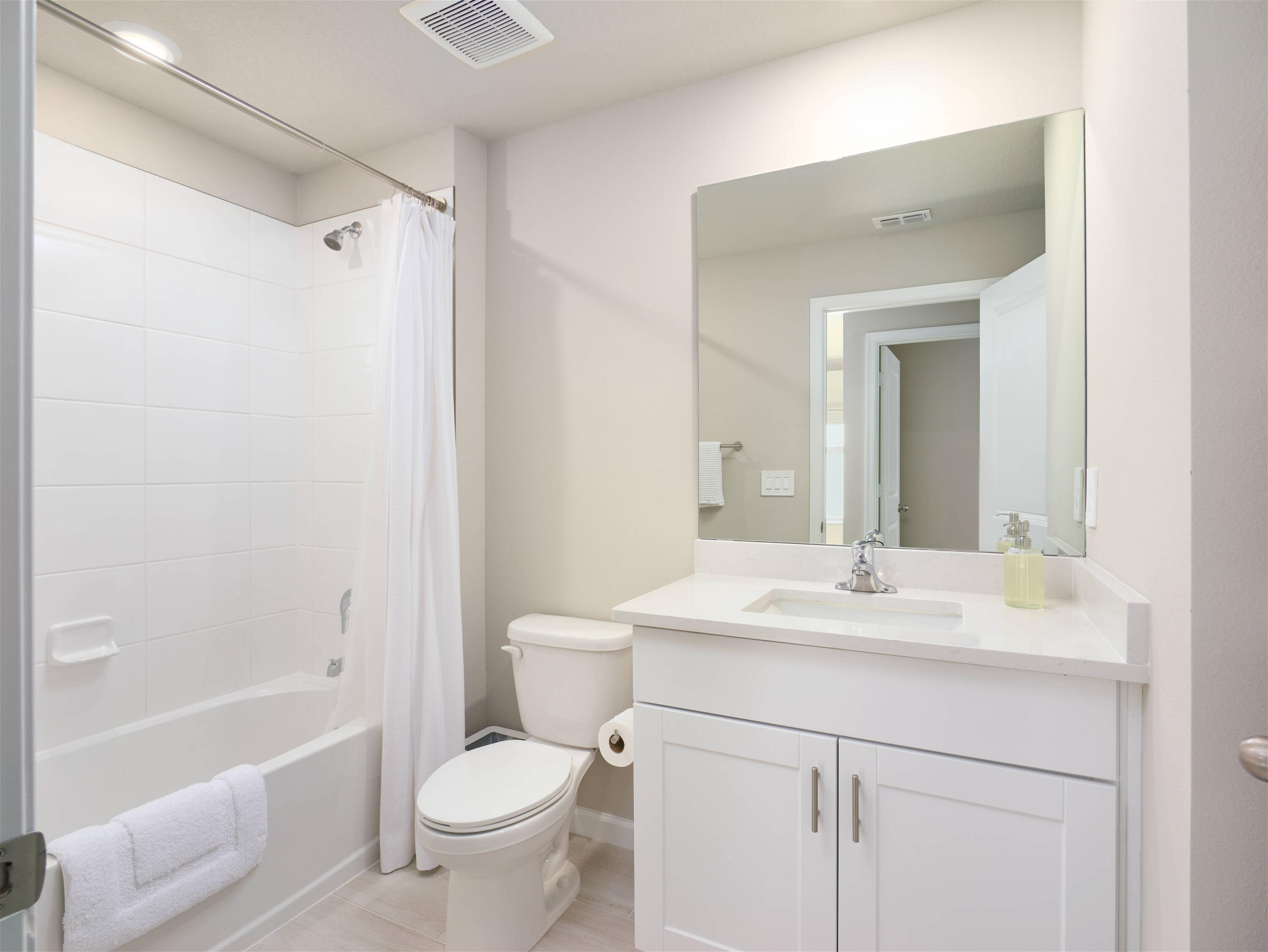 5735 Southeast Edgewater Circle Stuart, FL 34997 - Photo 21 of 39 a bathroom with a sink toilet vanity tub and shower