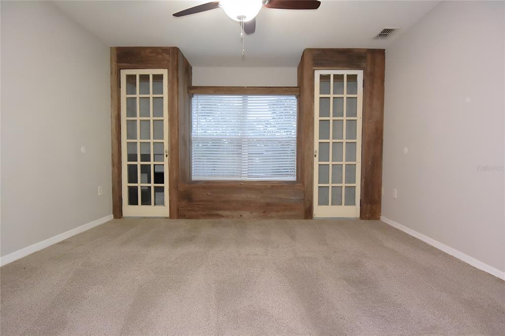 12042 Linden Drive Spring Hill, FL 34608 - Photo 21 of 41 an empty room with windows