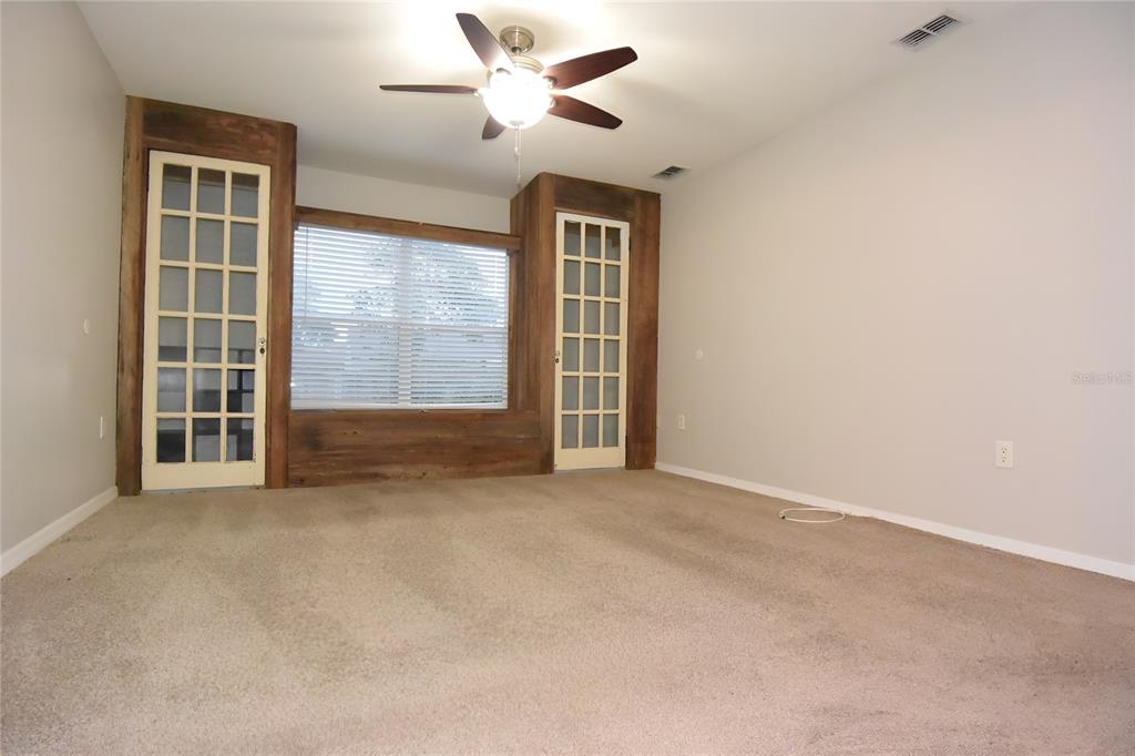 12042 Linden Drive Spring Hill, FL 34608 - Photo 22 of 41 an empty room with windows